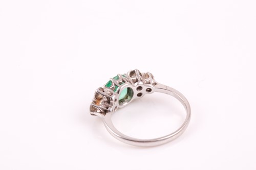 Lot 216 - A platinum, diamond, and emerald ring, set...