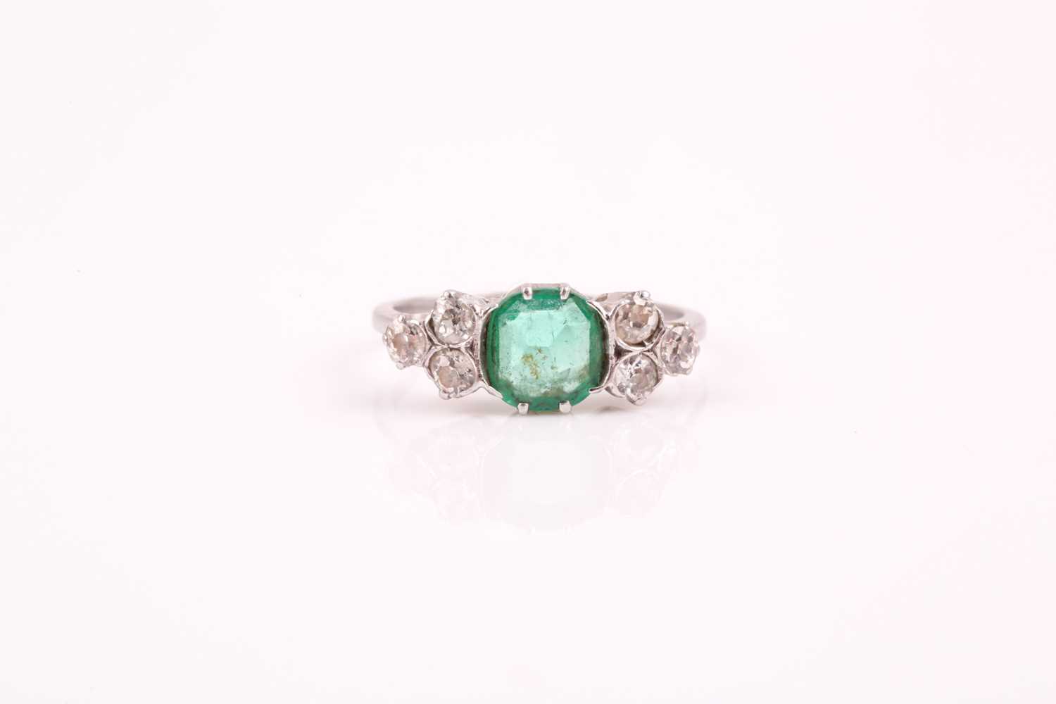 Lot 216 - A platinum, diamond, and emerald ring, set...