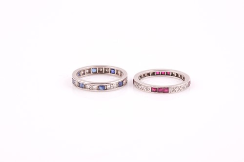 Lot 204 - A diamond and sapphire eternity ring, set with...