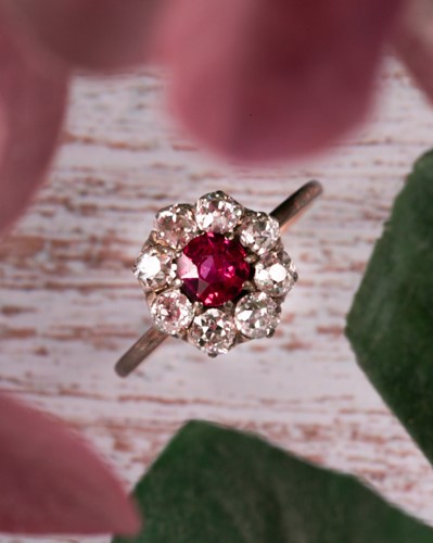 Lot 154 - A French ruby and diamond cluster ring, the...