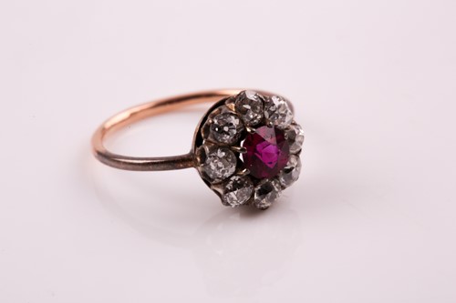 Lot 154 - A French ruby and diamond cluster ring, the...