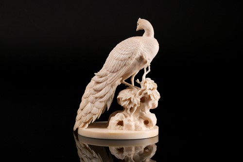 Lot 1 - A Japanese ivory okimono of a peacock, Meiji...
