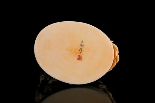Lot 1 - A Japanese ivory okimono of a peacock, Meiji...