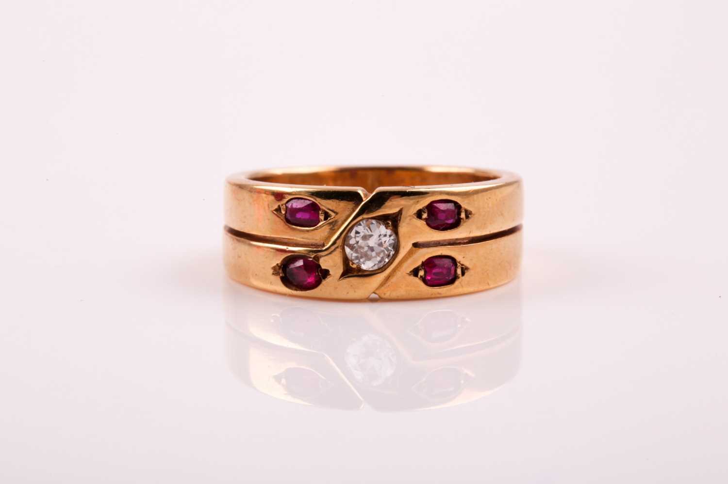 Lot 318 - A two row ruby and diamond ring; the central...