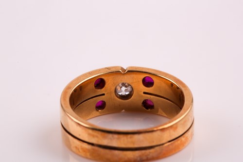 Lot 318 - A two row ruby and diamond ring; the central...
