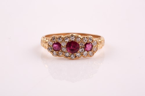 Lot 88 - An 18ct yellow gold, diamond, and ruby ring,...