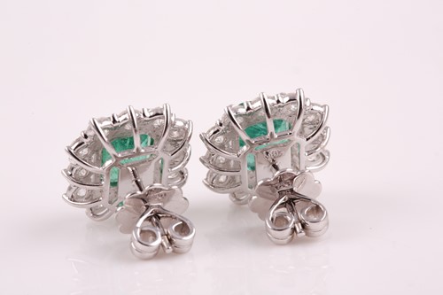 Lot 314 - A pair of diamond and emerald earrings, set...