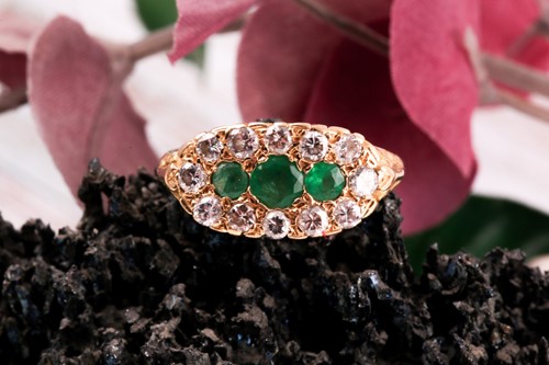 Lot 244 - An emerald and diamond half hoop ring; the...
