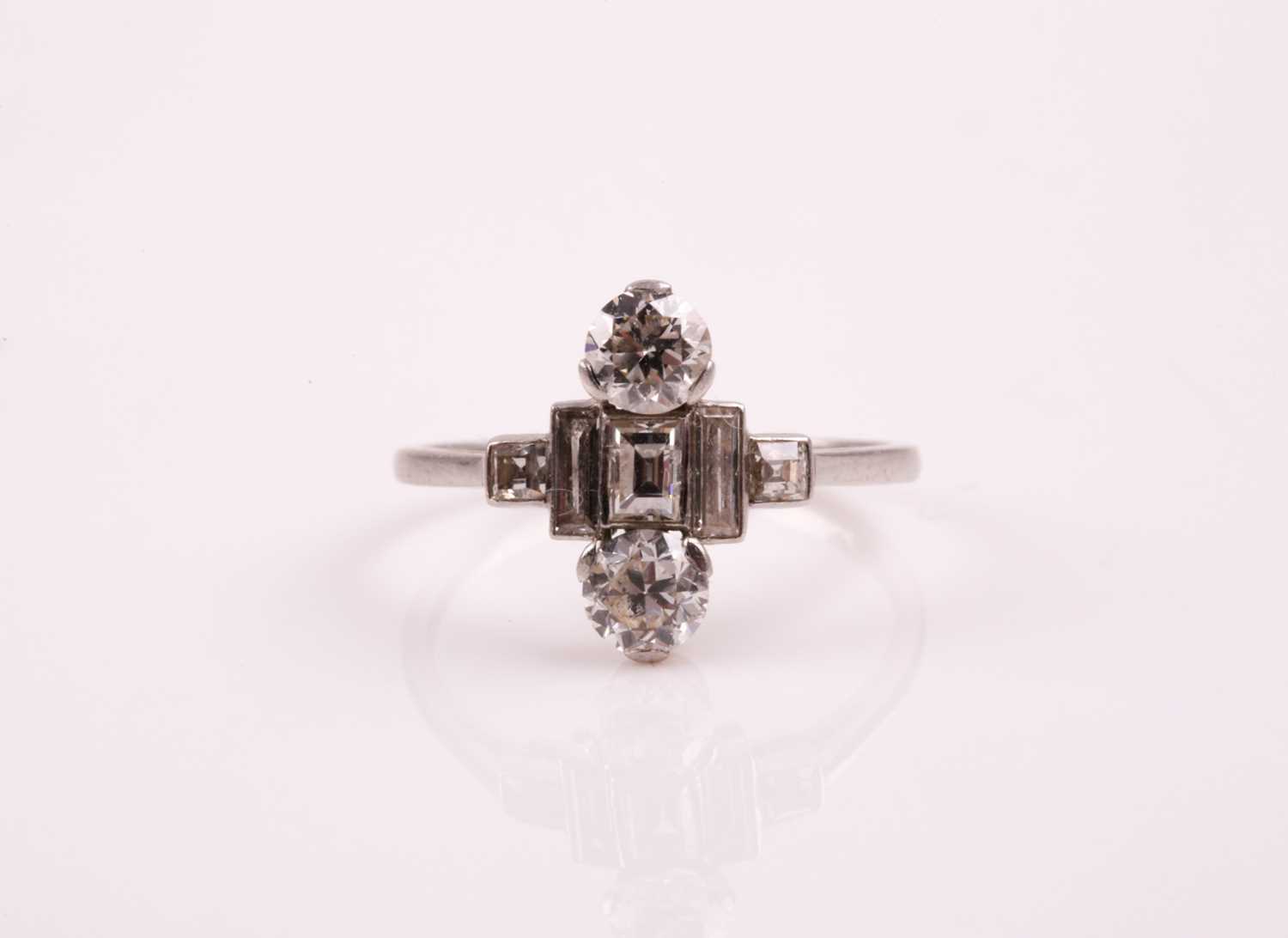 Lot 65 - An Art Deco diamond ring; set with two round...