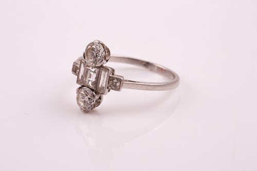 Lot 65 - An Art Deco diamond ring; set with two round...
