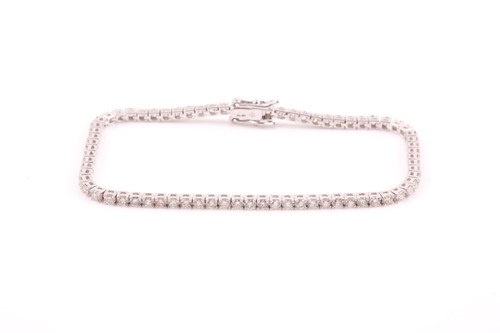 Lot 25 - An 18ct white gold and diamond line bracelet,...