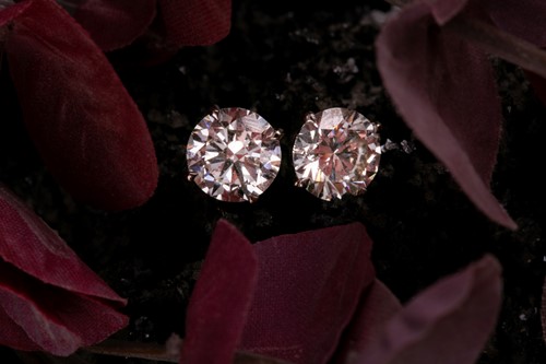 Lot 180 - A pair of round brilliant-cut diamond earrings,...