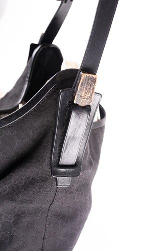 Lot 418 - A Gucci black leather and canvas handbag, a...