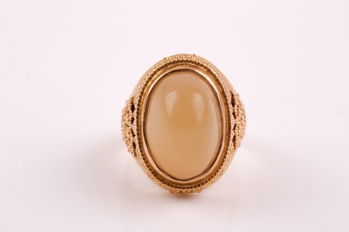 Lot 364 - A yellow metal and onyx ring, the pale green...
