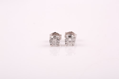 Lot 221 - A pair of solitaire diamond earrings, the...