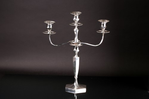Lot 469 - An early 20th century three branch candleabrum,...