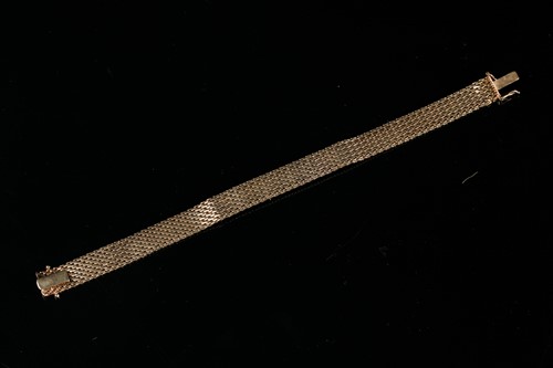 Lot 203 - A 9ct yellow gold, diamond, and ruby bracelet,...