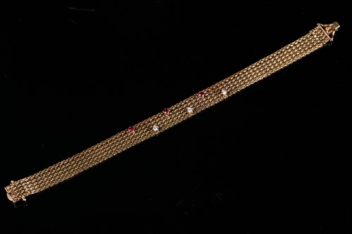 Lot 203 - A 9ct yellow gold, diamond, and ruby bracelet,...