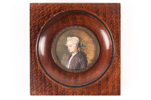 Lot 410 - A wood-framed portrait miniature of a young...