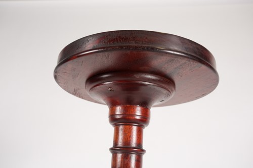 Lot 277 - A George III style stained wood torchere with...