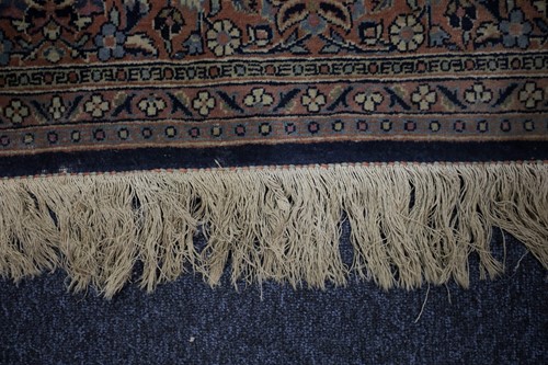 Lot 313 - A 20th century Kashan rug with a flower-filled...
