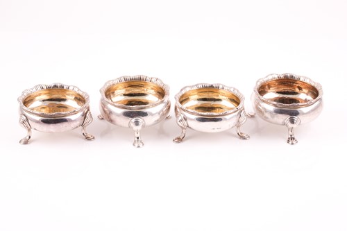 Lot 425 - A set of four George II silver salts each on...