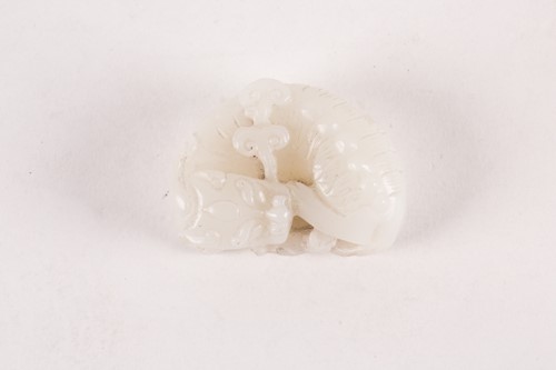 Lot 16 - A Chinese carved white jade figure of a...