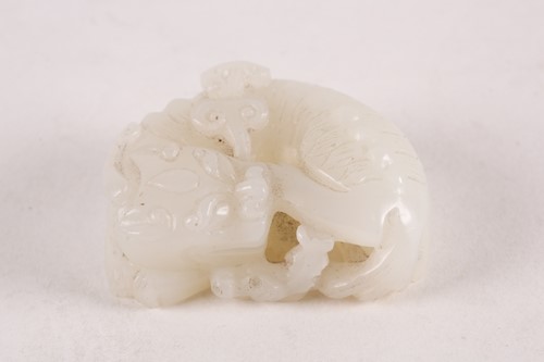 Lot 16 - A Chinese carved white jade figure of a...