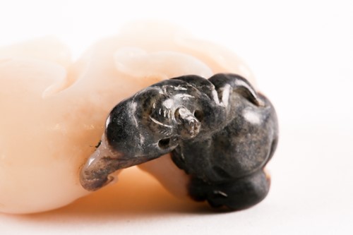 Lot 127 - A Chinese, carved off-white and grey jade,...