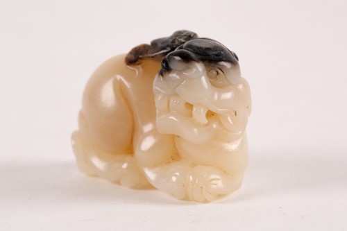 Lot 127 - A Chinese, carved off-white and grey jade,...