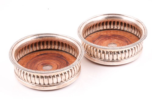 Lot 548 - A pair of George III silver coasters with...