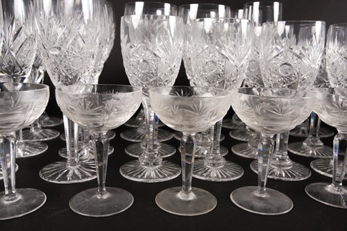 Lot 405 - A part suite of cut glass drinking glasses,...