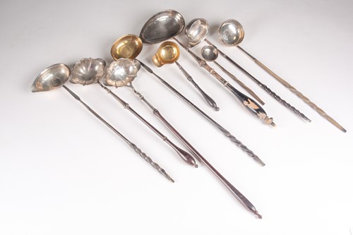 Lot 464 - A collection of toddy ladles; including a coin...