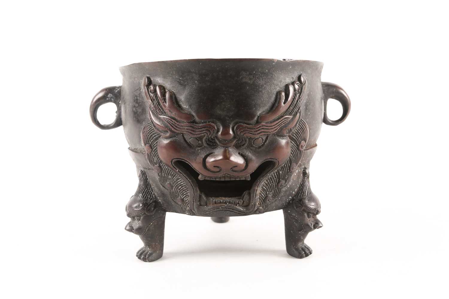 Lot 151 - A Chinese patinated bronze circular charcoal...