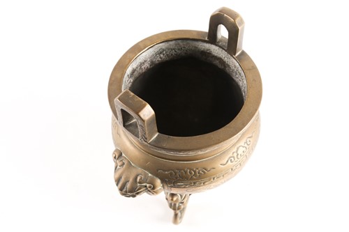 Lot 60 - A Chinese bronze two-handled tripod censer...