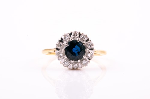 Lot 469 - A sapphire and diamond cluster ring, the...