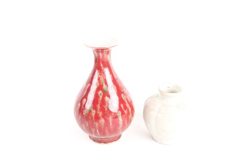 Lot 159 - A Chinese white glazed segmented globular vase,...