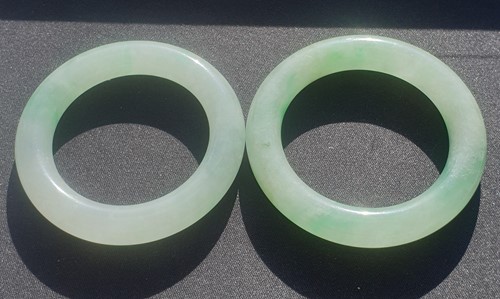 Lot 80 - A near pair of Chinese jade bangles, each...