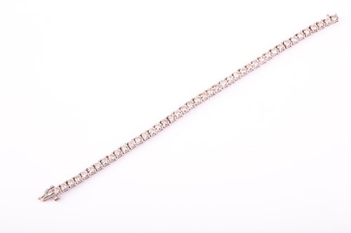 Lot 363 - A diamond line bracelet, the forty three...
