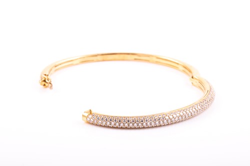 Lot 228 - An 18ct gold and diamond bangle, the hinged D...
