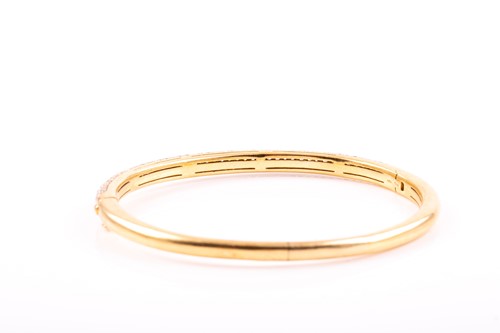 Lot 228 - An 18ct gold and diamond bangle, the hinged D...