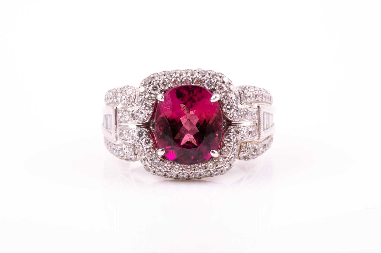 Lot 475 - A pink tourmaline and diamond dress ring; the...