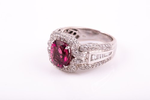 Lot 475 - A pink tourmaline and diamond dress ring; the...