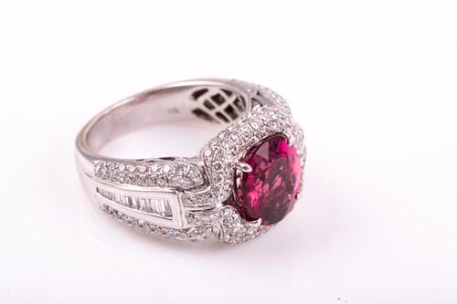 Lot 475 - A pink tourmaline and diamond dress ring; the...