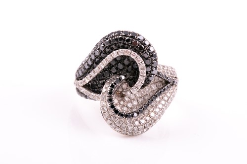 Lot 374 - A white and black diamond dress ring, the...