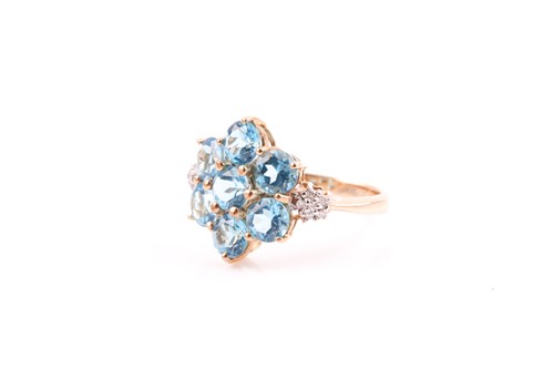 Lot 203 - A 9ct yellow gold and blue topaz floral...