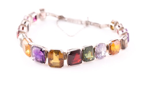 Lot 98 - A graduated multi-gem set bracelet, the...
