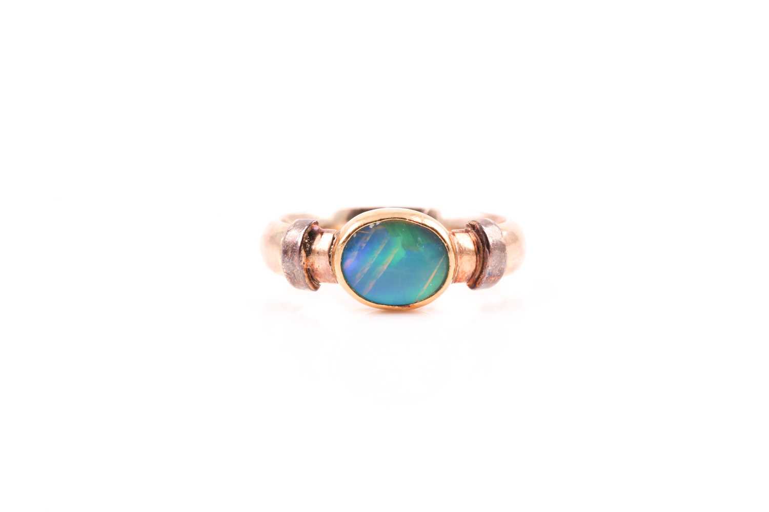 Lot 12 - A 9ct yellow gold and doublet opal ring,...