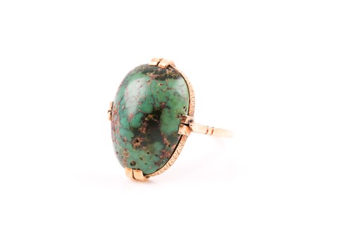 Lot 33 - A yellow metal and turquoise ring, set with a...