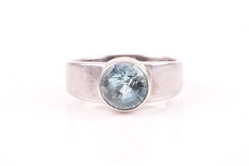 Lot 71 - A white metal and aquamarine ring, collet-set...